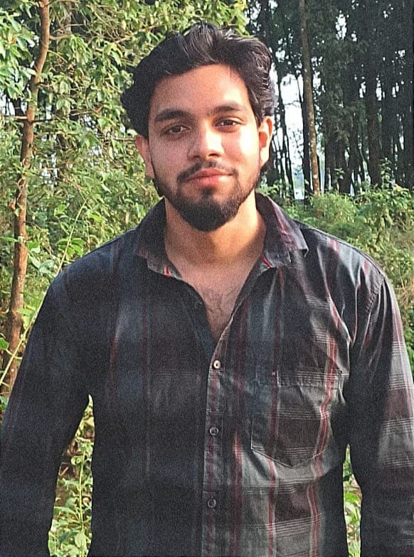 Portrait of Abhishek Jha outdoors among trees